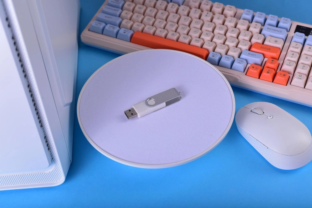 Plain white swivel USB flash drive on a desk with keyboard and mouse, ready for logo branding
