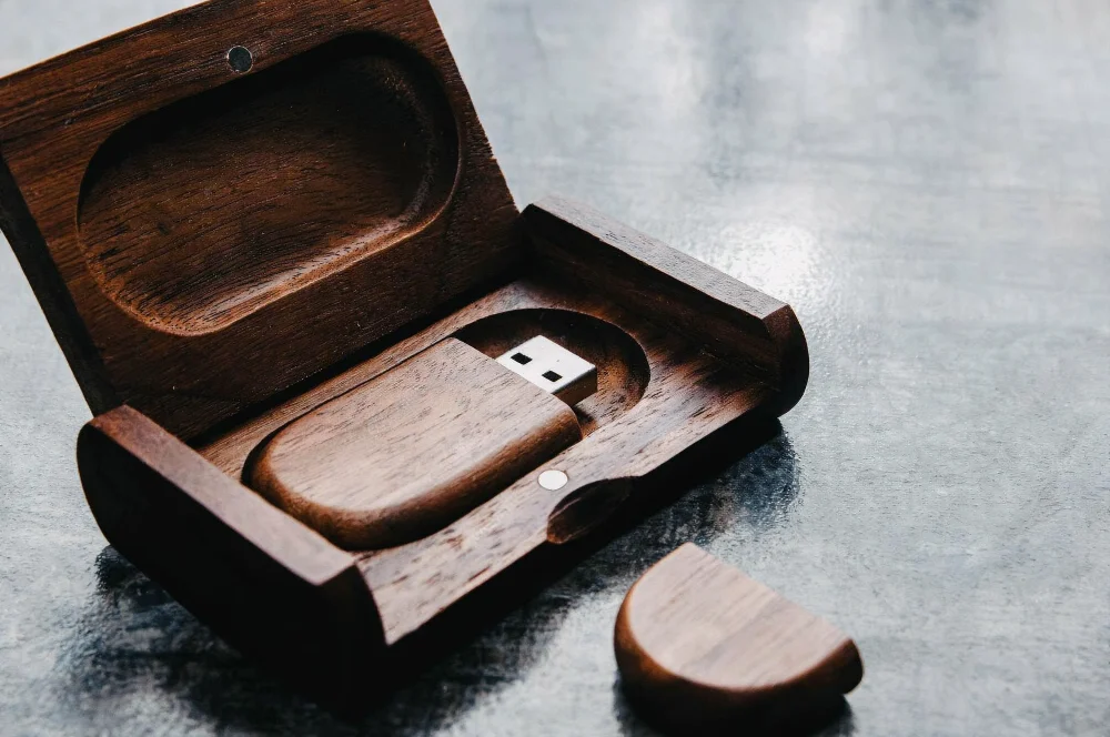 Wooden USB flash drive inside an engraved wooden gift box, a premium packaging option for corporate USB gifts