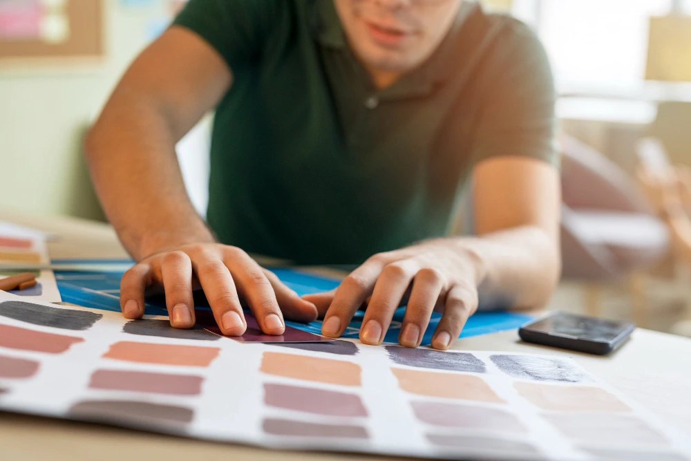 Business owner reviewing colour and material swatches to choose the right signage finish