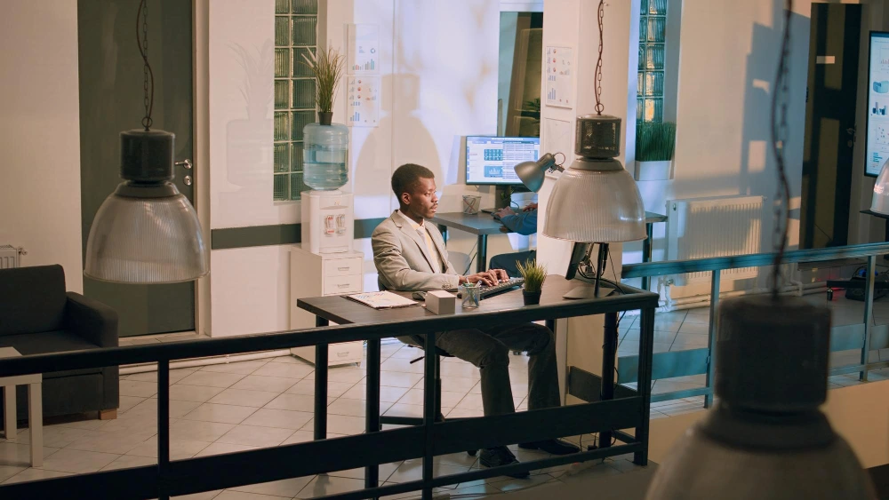 Startup founder working at a desk in a Dubai office after registering a new company